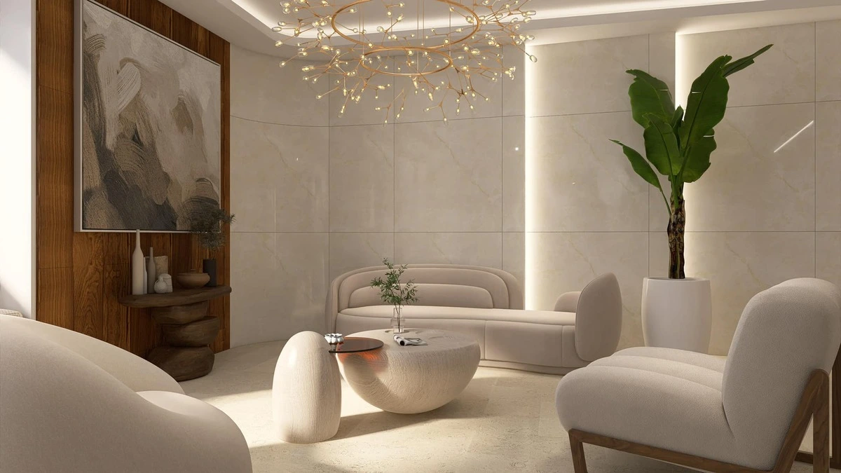 Salon élégant avec fauteuils en tissu crème, table basse sculpturale et éclairage design, illustrant une décoration d'intérieur moderne et épurée.